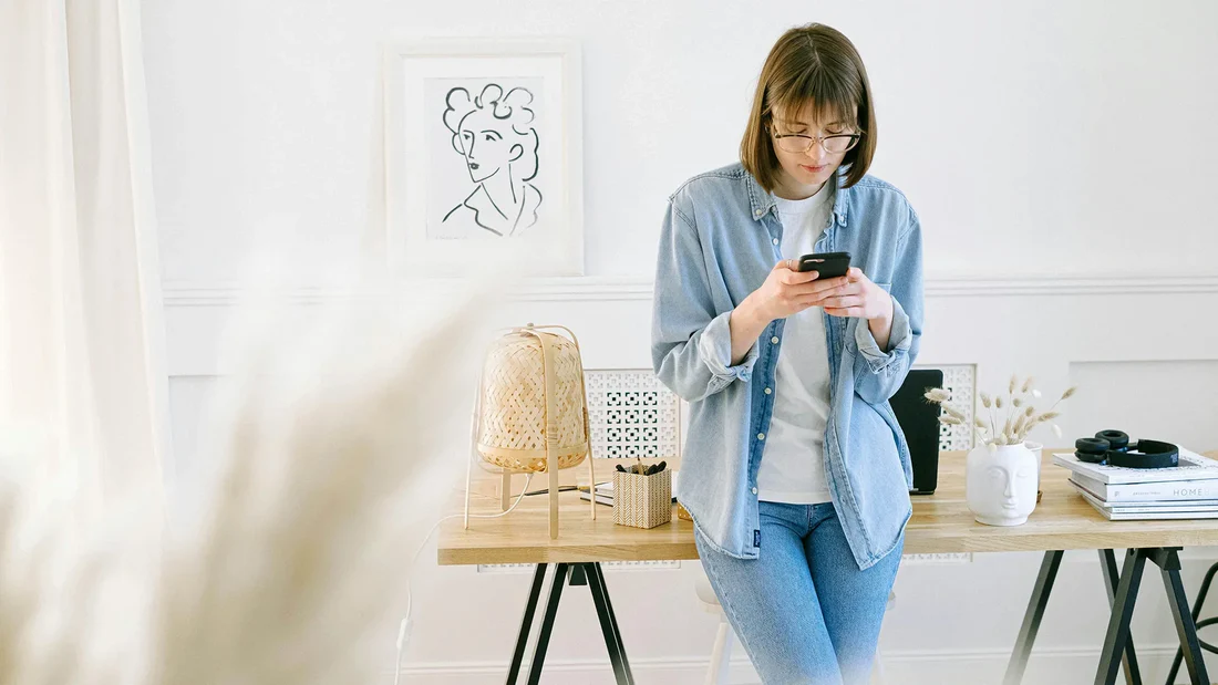 Office employee standing at a desk reviewing a daily activity plan during a movement break